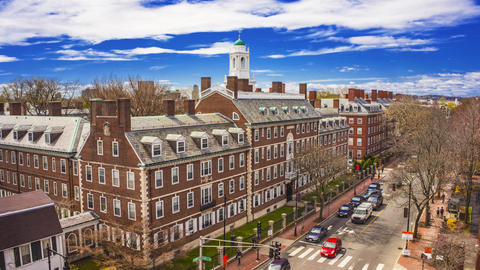Looking down on a street lined with historic brick buildings under a mostly clear sky