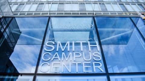 A modern building with "Smith Campus Center" written in large letters on a glass atrium