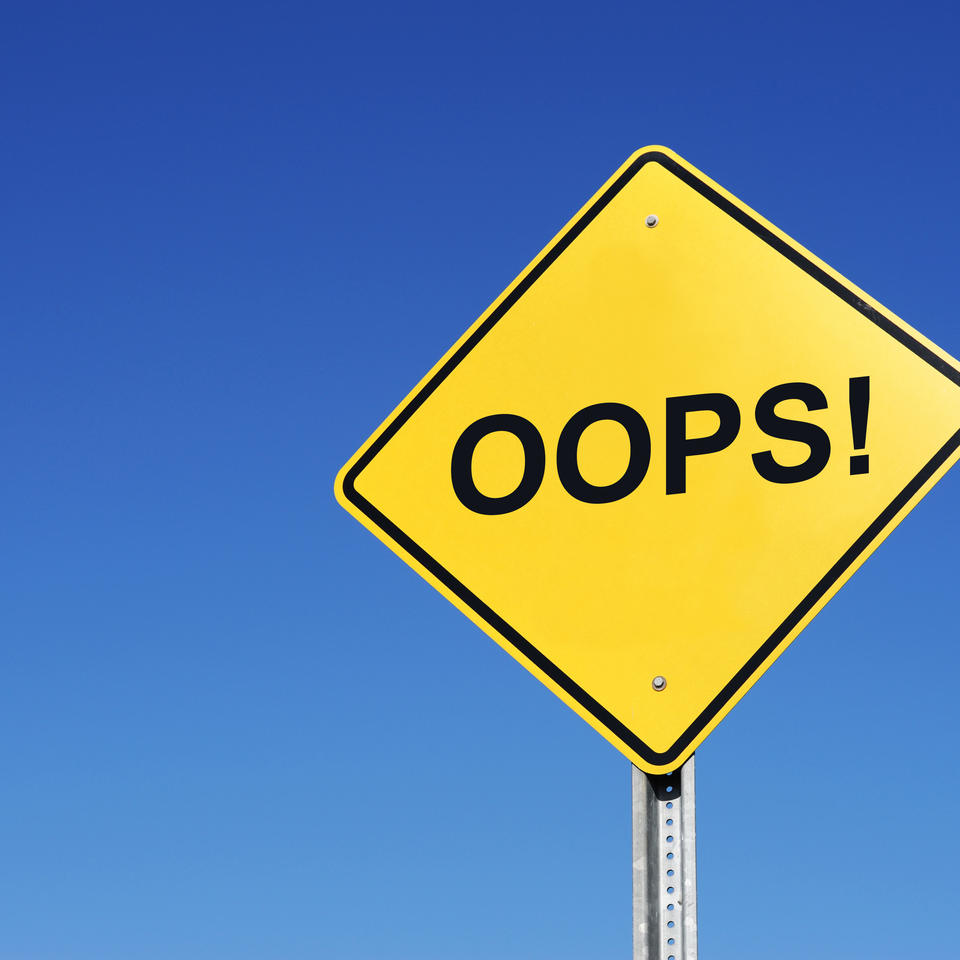 A road sign with the word "Oops!"